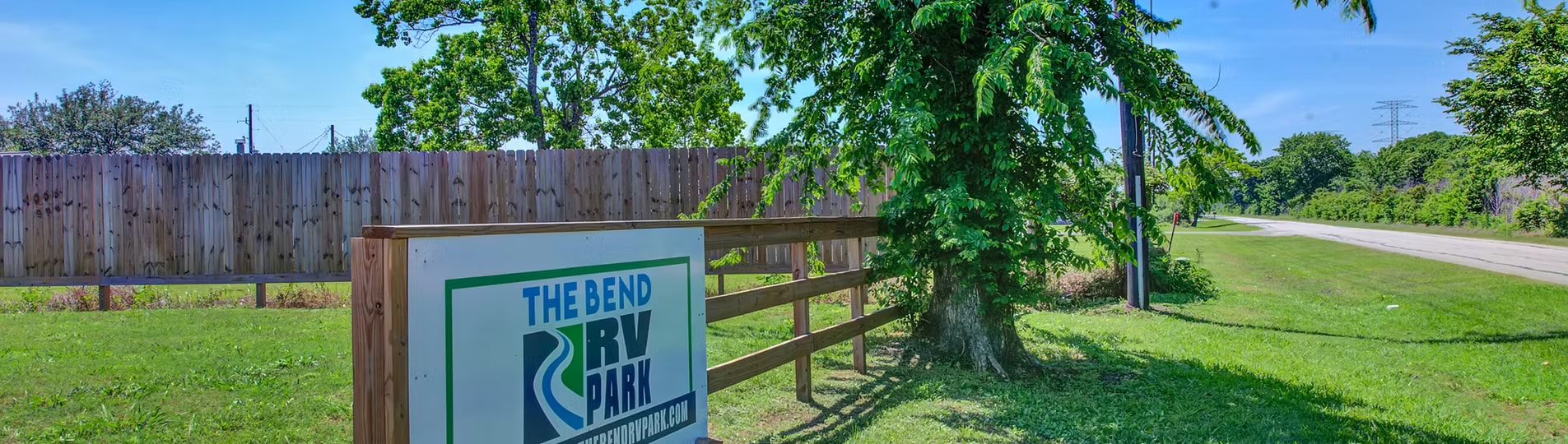 The Bend RV Park entrance sign surrounded by trees and fencing