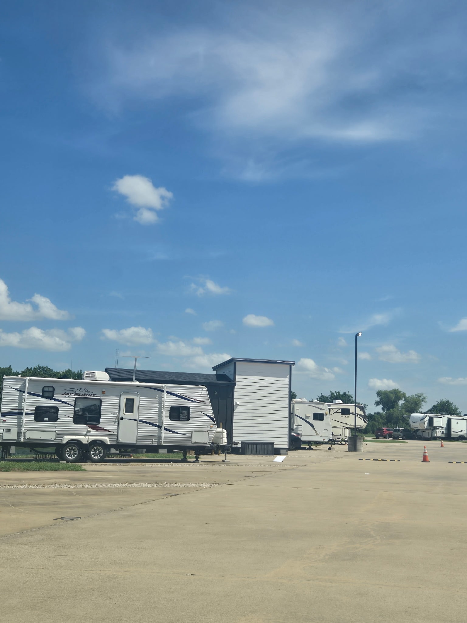 RV sites with Jay Flight and fifth-wheel trailers parked at The Bend RV Park